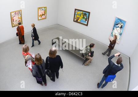 Visitors observe paintings of the exhibition 'Women' at the Pinakothek der Moderne in Munich, Germany, 29 March 2012. On the occasion of its 10th anniversary the Pinakothek der Moderne presents a view on femininity from the perspective of three 20th century painters. The exhibition titled 'Women' opens on 29 March 2012 and runs till 15 July 2012. Photo: FELIX HOERHAGER Stock Photo