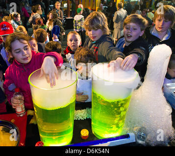 Children touch and watch a bubbling liquid at interactive museum Extavium in Potsdam, Germany, 20 March 2012. Photo: Patrick Pleul Stock Photo