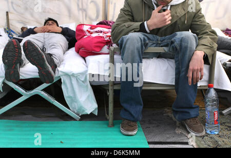 Iranians rest on beds in a pavillon in Wuerzburg, Germany, 03 April 2012. For more than two weeks the Iranians have been on a hunger strike. They wish to draw attention to long processings of asylum applications and the situation in the community homes. They also wish to become recognised as political refugees. Photo: KARL-JOSEF HILDENBRAND Stock Photo