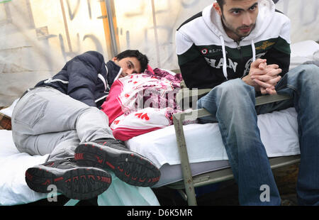 Iranians rest on beds in a pavillon in Wuerzburg, Germany, 03 April 2012. For more than two weeks the Iranians have been on a hunger strike. They wish to draw attention to long processings of asylum applications and the situation in the community homes. They also wish to become recognised as political refugees. Photo: KARL-JOSEF HILDENBRAND Stock Photo