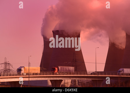 lorrys passing ferrybridge power station at sunrise on the m62 motorway Yorkshire UK Stock Photo