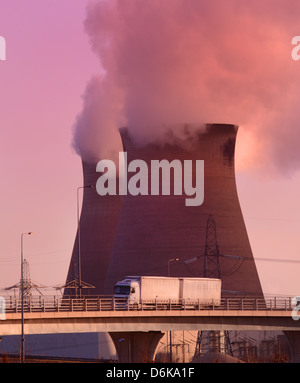 lorrys passing ferrybridge power station at sunrise on the m62 motorway Yorkshire UK Stock Photo