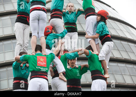 Human Tower, Potters Fields, Tower Bridge, London, UK. 19th April, 2013.  For the first time Castellers de Vilafranca build a Human Tower at Potters Fields, Tower Bridge, London, UK  170 members of the Castellers de Vilafranca team form successively smaller tiers by climbing up the bodies of each layer to mount the shoulders of the previous tier until the tower is complete. A uniquely Catalan custom, the Human Towers have been constructed during town celebrations and festivals in Barcelona for 300 years. Stock Photo