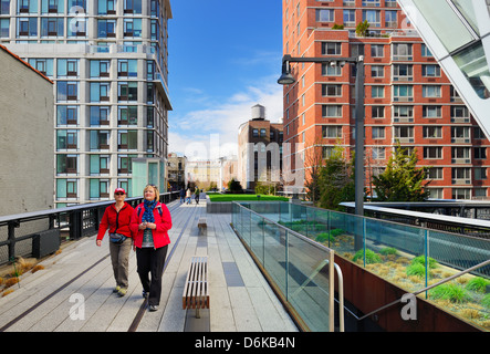 Pedestrians stroll atop the High Line April 13, 2013 in New York City, USA. Stock Photo