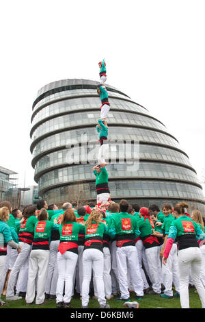 Human Tower, Potters Fields, Tower Bridge, London, UK. 19th April, 2013.  For the first time Castellers de Vilafranca build a Human Tower at Potters Fields, Tower Bridge, London, UK  170 members of the Castellers de Vilafranca team form successively smaller tiers by climbing up the bodies of each layer to mount the shoulders of the previous tier until the tower is complete. A uniquely Catalan custom, the Human Towers have been constructed during town celebrations and festivals in Barcelona for 300 years. Stock Photo