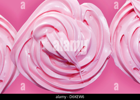 Top view macro of pink frosting over cupcakes. Stock Photo