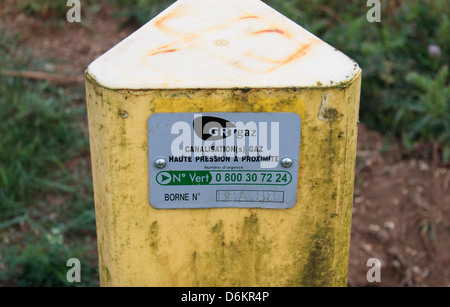 Generic road side marker beside a field in northern France indicating underground natural gas pipelines. Stock Photo