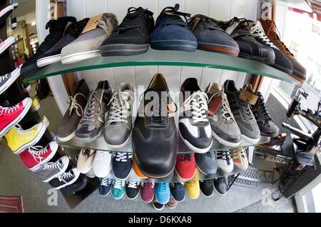 Oversized men's shoes stand on a shelf in the sales room of shoemaker Georg Wessels in Vreden, Germany, 15 April 2013. Wessels manufactures shoes for people with large shoe sizes all around the world. Photo: Friso Gentsch Stock Photo