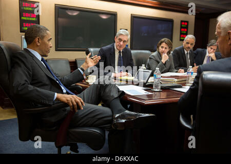 US President Barack Obama meets with members of his national security team to discuss developments in the Boston bombings investigation in the Situation Room of the White House April 19, 2013 in Washington, DC. Pictured, from left, are: FBI Director Robert Mueller; Lisa Monaco, Assistant to the President for Homeland Security and Counterterrorism; Attorney General Eric Holder; Deputy National Security Advisor Tony Blinken; and Vice President Joe Biden. Stock Photo