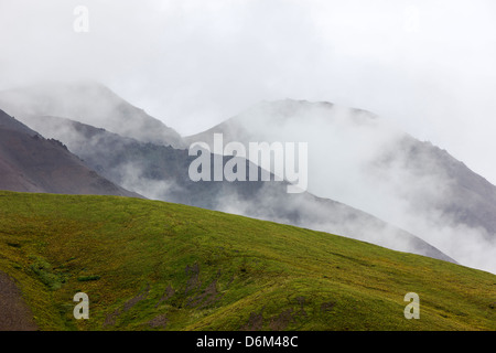 Misty foggy view south of the Alaska Range from Polychrome Pass, Denali National Park, Alaska, USA Stock Photo