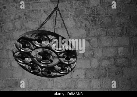 Black and White image of a medieval chandelier in a castle interior Stock Photo