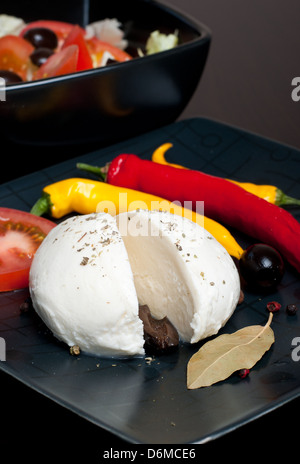 Mozarella and chilli on black composition Stock Photo