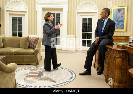 US President Barack Obama receives an update on the arrest of the second suspect in the Boston bombing investigation from Lisa Monaco, Assistant to the President for Homeland Security in the Oval Office of the White House April 19 2013 in Washington, DC. Stock Photo