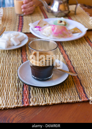 Coffee and petite cakes on table in cafe in Marrakech, Morocco, North Africa Stock Photo