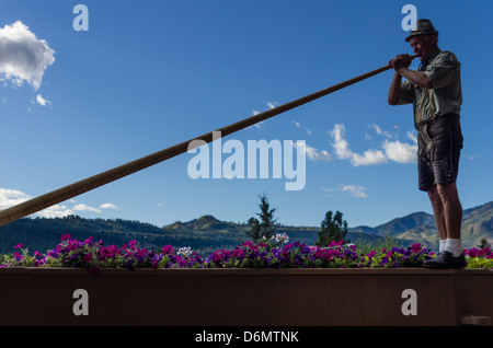 Man playing an Alpenhorn in Leavenworth, Washington, USA Stock Photo