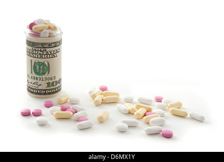 Bottle made of money full of colorful pills, on white background. Stock Photo