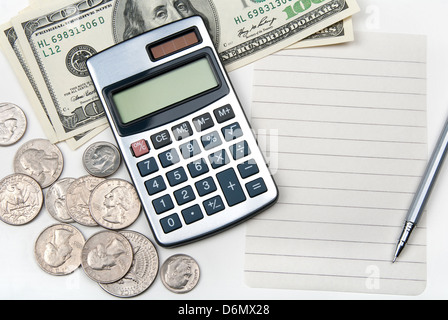 Calculator, money, pen and empty lined paper to white a shopping list. Stock Photo