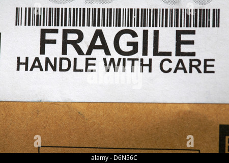 fragile handle with care sticker and barcode on package packaging box -cardboard box fragile Stock Photo