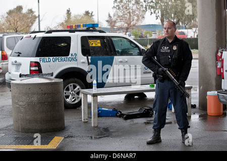 A US Customs and Border Protection officer watches the San Luis border crossing February 16, 2012 in San Luis, AZ. Stock Photo
