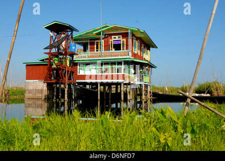 Traditional house built on stilts over Inle Lake with colourful veranda Stock Photo