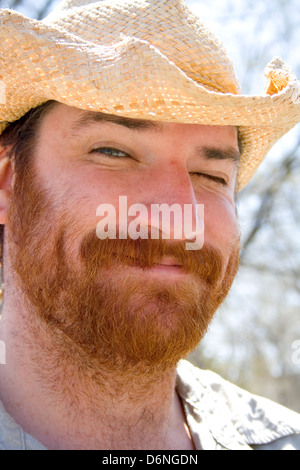 Happy charming bearded man wearing a straw hat. MayDay Parade and Festival Minneapolis Minnesota MN USA Stock Photo