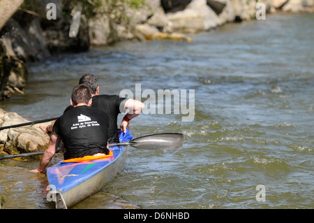 Kayakers and canoeists competing in Piloña River, Asturias, Spain. Stock Photo