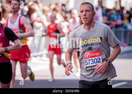 LONDON, Lower Thames Street, 21 April 2013.  Competitor 57302 in the Virgin London Marathon, wears a T shirt and a black ribbon supporting the victims of the Boston marathon bombing which took place five days previously. Stock Photo