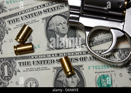 handgun on us dollars cash with used 9mm shells Stock Photo