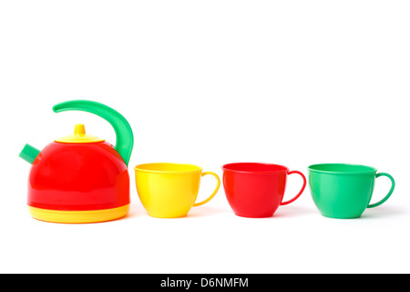 teapot and three cups in row toys isolated on white Stock Photo