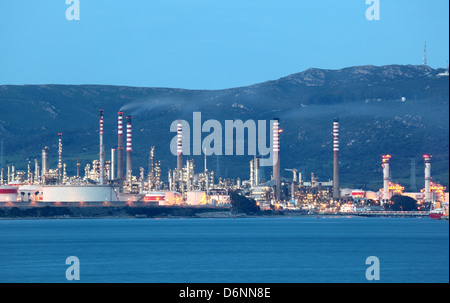 Oil refinery illuminated at dusk Stock Photo