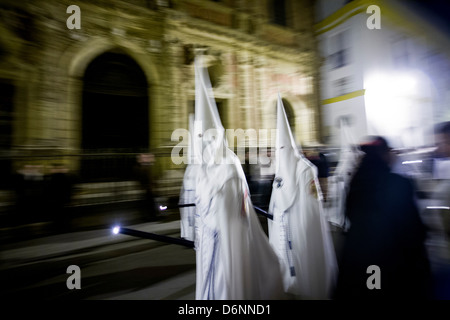 Seville, Spain, believers with pointed hoods in a procession for Semana Santa Stock Photo