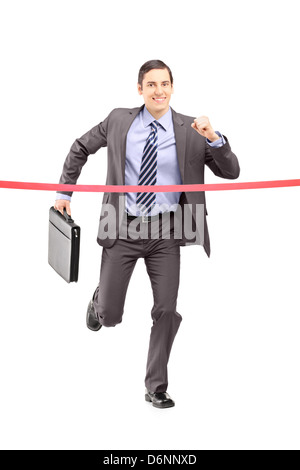 Full length portrait of a businessman running with a briefcase and reaching the finish line isolated on white background Stock Photo