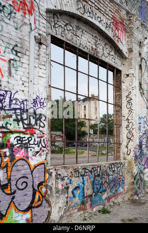 Berlin, Germany, sprayed with graffiti factory wall with transom remote Rochester Stock Photo