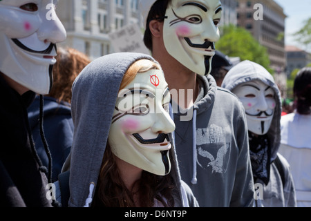 A group of people wearing Guy Fawkes masks at a rally Stock Photo