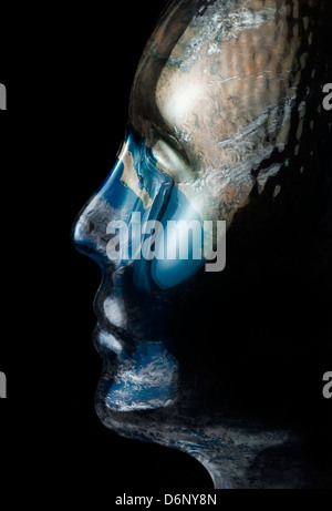 translucent reflective human head made of glass with global surface on it in black back Stock Photo