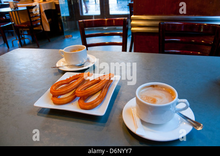 Coffee with churros for breakfast. Madrid, Spain. Stock Photo