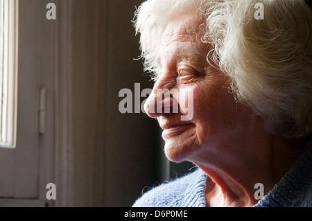 Profile portrait of old woman smiling. Close view. Stock Photo