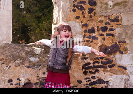 Little Girl Standing Up Laughing with her arms out wide Stock Photo