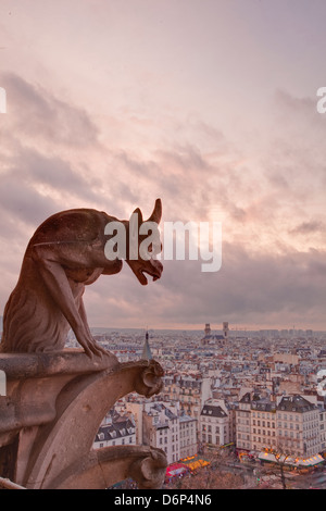 A gargoyle on Notre Dame de Paris cathedral looks over the city, Paris, France, Europe Stock Photo