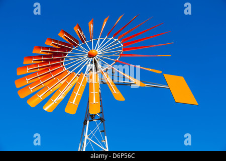 Close up of an Orange Windmill against a clear blue sky Stock Photo