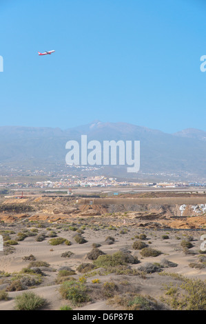 Plane taking off from Reina Sofia Tenerife south airport over El Medano town Tenerife island the Canary Islands Spain Europe Stock Photo