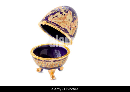 Casket of blue color with a gold list. It is executed in the form of an Easter egg, it is painted with scenes from antique life Stock Photo