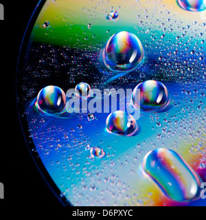 water drops on shiny surface, rainbow colours, close up Stock Photo