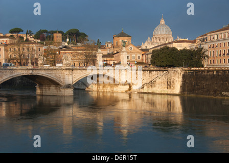 ROME, ITALY. A dawn view of the River Tiber and Ponte Vittorio Emanuele II, with St. Peter's Basilica in the distance. 2013.
