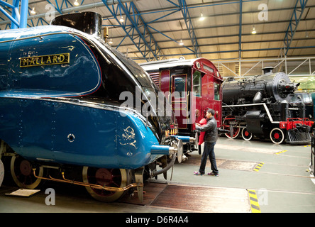 A man showing his child the Mallard A4 class steam engine; National Railway Museum, York UK Stock Photo