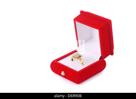 Golden ring in a red velvet box isolated on white background