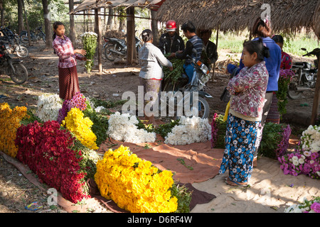 Woman selling flowers in a flower market, Mandalay, Myanmar, (Burma) Stock Photo