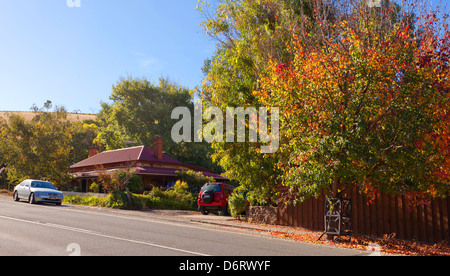 house front green fence old cottage gate footpath main street Clarendon Adelaide Hills South Australia autumn leaves Stock Photo