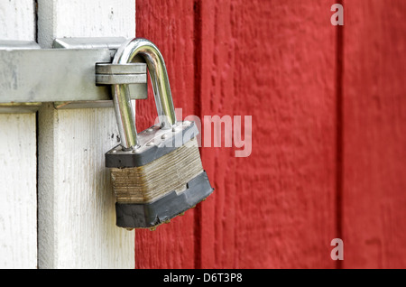 Padlock on red barn door Stock Photo