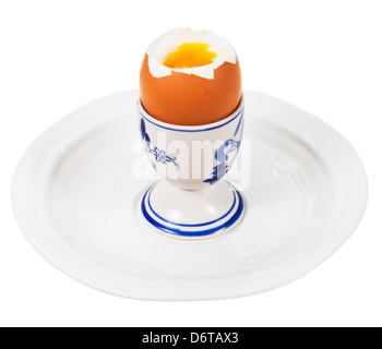 soft boiled egg in egg cup on white plate isolated on white Stock Photo